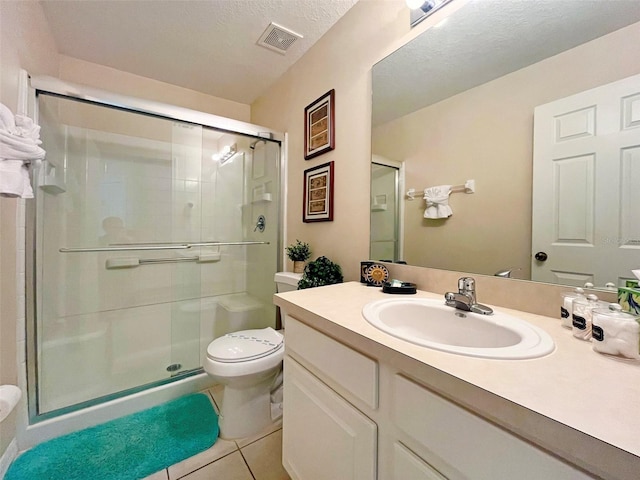 bathroom with vanity, toilet, an enclosed shower, and tile patterned floors