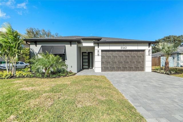 view of front of home featuring a garage and a front yard