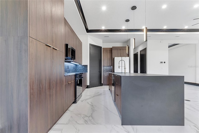 kitchen with backsplash, hanging light fixtures, white fridge, a large island, and black range with electric stovetop