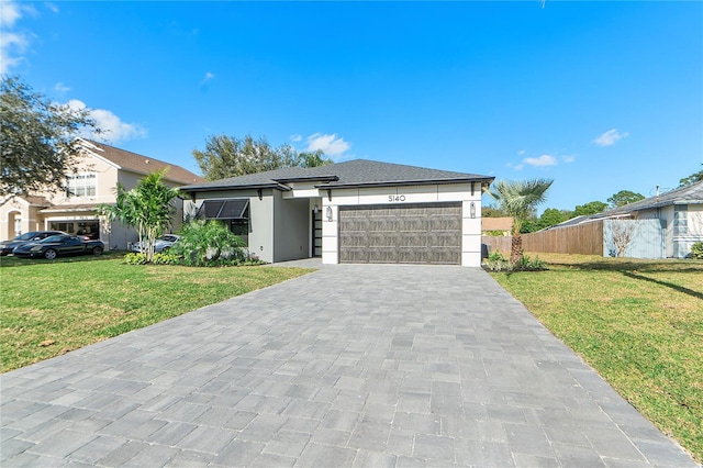 view of front facade with a garage and a front lawn