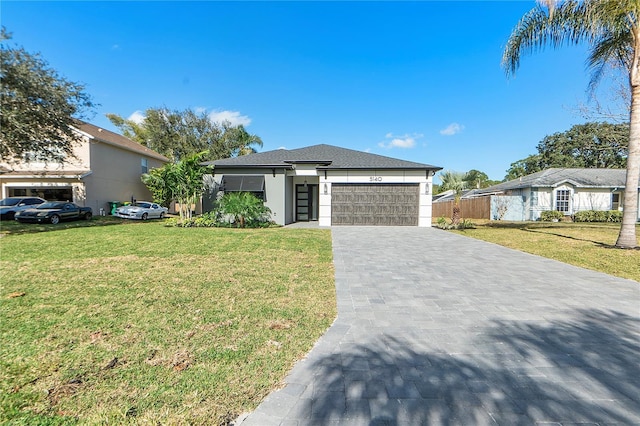 view of front facade featuring a garage and a front lawn