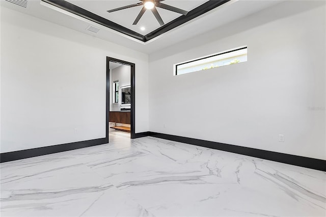 unfurnished room with a tray ceiling and ceiling fan