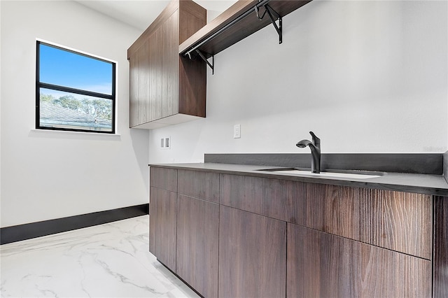 kitchen featuring dark brown cabinetry and sink