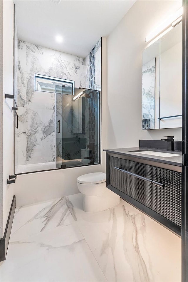 full bathroom with vanity, combined bath / shower with glass door, and toilet