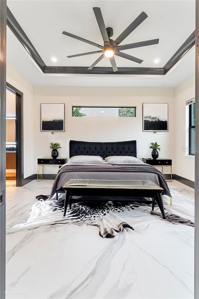 bedroom with crown molding, a raised ceiling, and ceiling fan