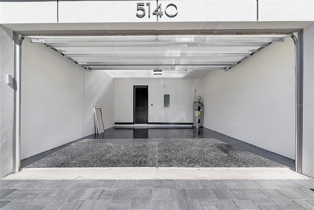 garage featuring water heater and electric panel