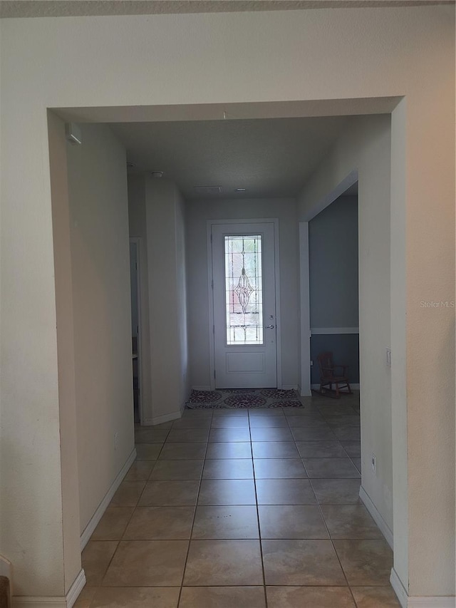 corridor with light tile patterned floors