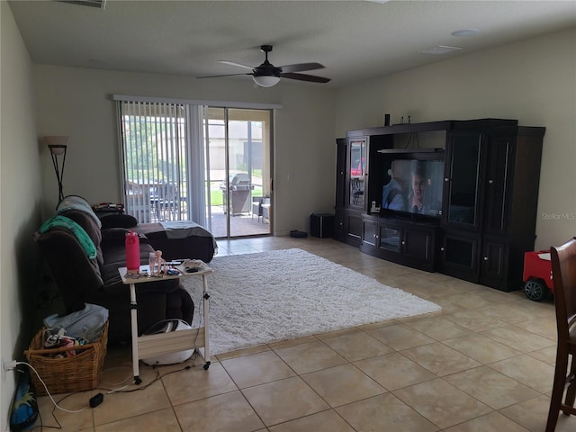 living room featuring light tile patterned floors and ceiling fan