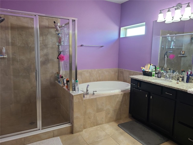 bathroom featuring vanity, shower with separate bathtub, and tile patterned flooring