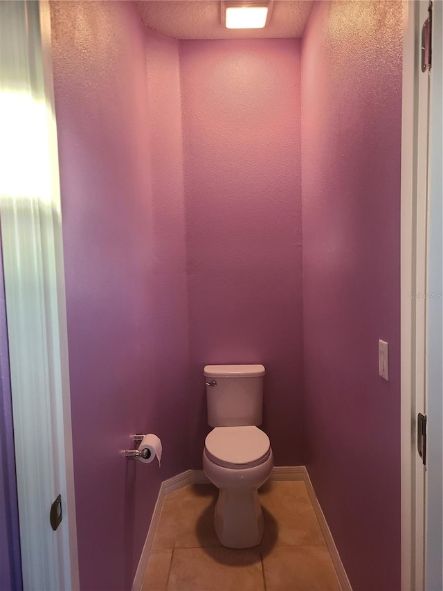 bathroom with tile patterned flooring and toilet