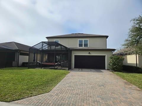 view of front of house with a garage, glass enclosure, and a front lawn