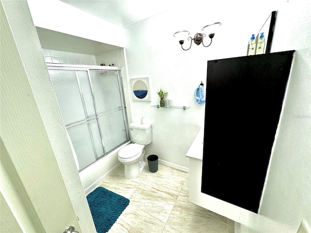 full bathroom with toilet, bath / shower combo with glass door, and vanity