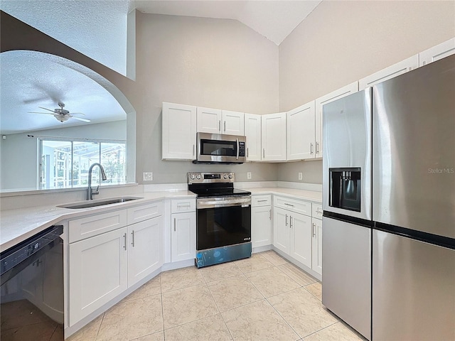 kitchen featuring appliances with stainless steel finishes, white cabinetry, sink, and ceiling fan