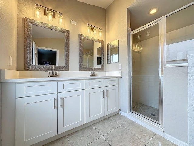 bathroom featuring tile patterned flooring, an enclosed shower, and vanity