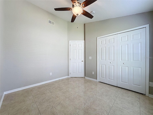 unfurnished bedroom featuring light tile patterned floors, ceiling fan, and a closet