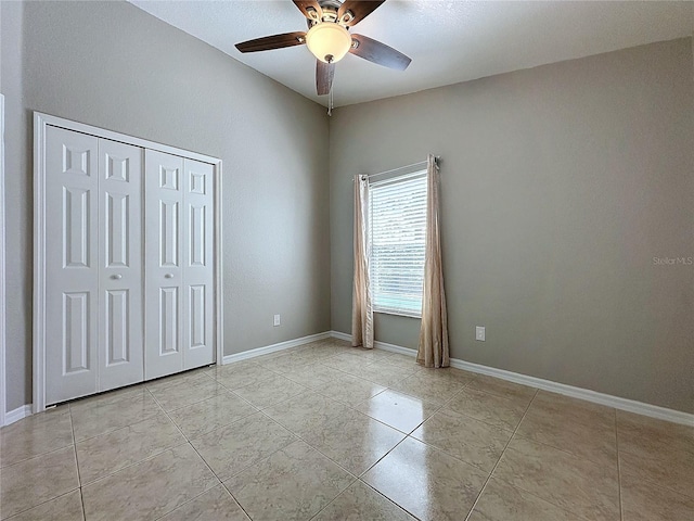 unfurnished bedroom with a closet, ceiling fan, and light tile patterned flooring