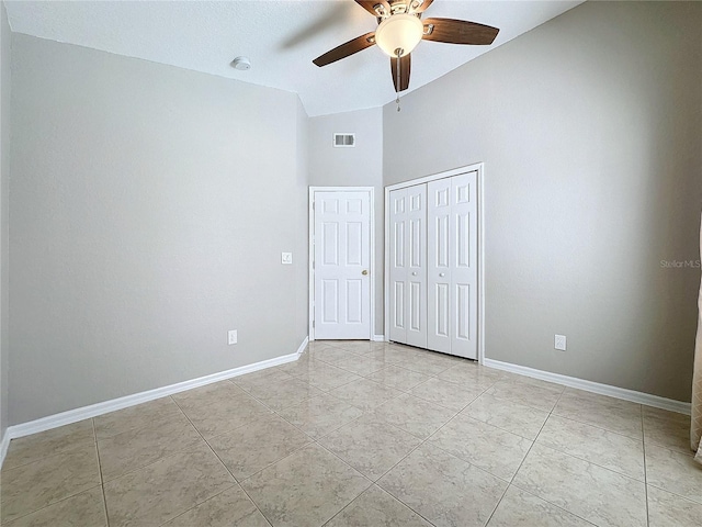 unfurnished room with vaulted ceiling, light tile patterned floors, and ceiling fan