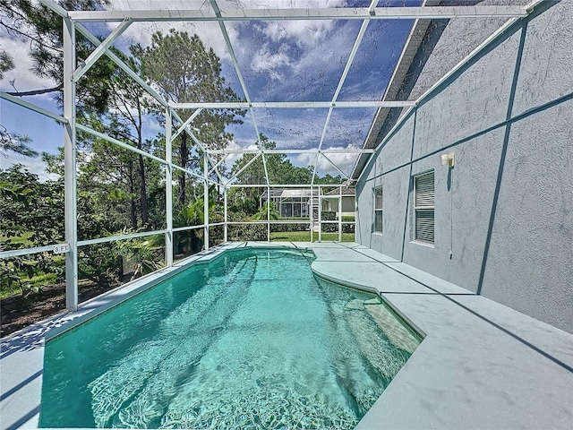 view of pool with a lanai and a patio