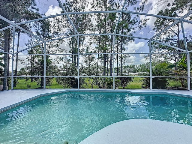 view of swimming pool featuring a lanai