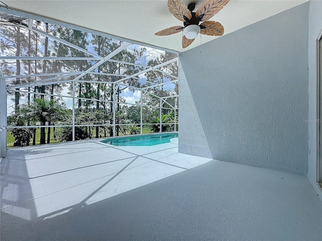 view of pool featuring a lanai, ceiling fan, and a patio