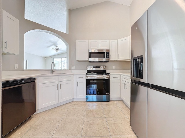 kitchen featuring light tile patterned floors, stainless steel appliances, sink, ceiling fan, and white cabinets