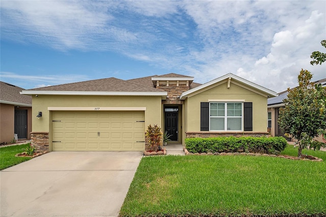 view of front of property with a garage and a front lawn