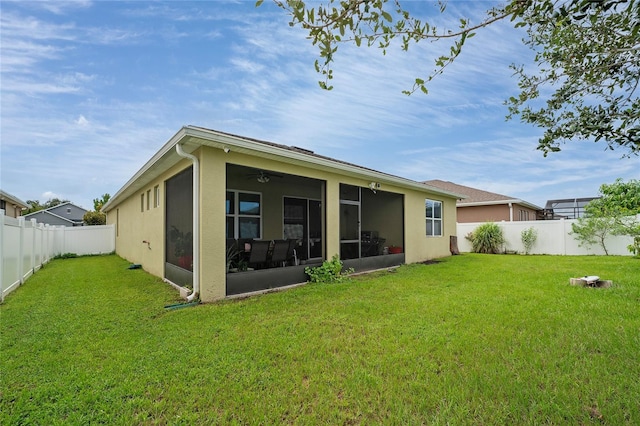 back of property featuring a sunroom and a lawn