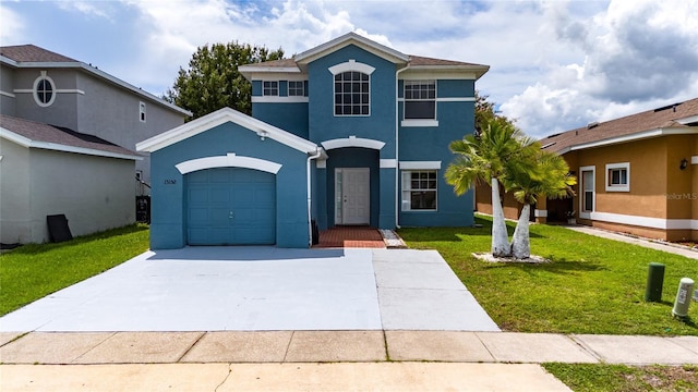 view of property with a garage and a front lawn