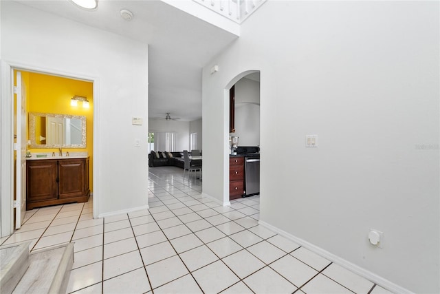 hall with light tile patterned flooring and sink