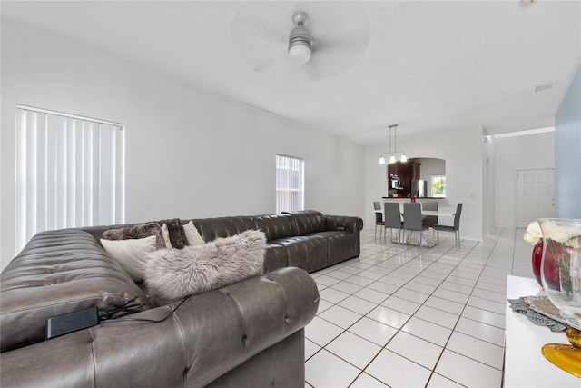 living room featuring ceiling fan and light tile patterned flooring