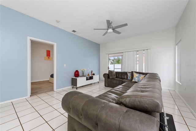 tiled living room featuring a textured ceiling and ceiling fan