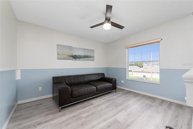 sitting room with light hardwood / wood-style flooring and ceiling fan