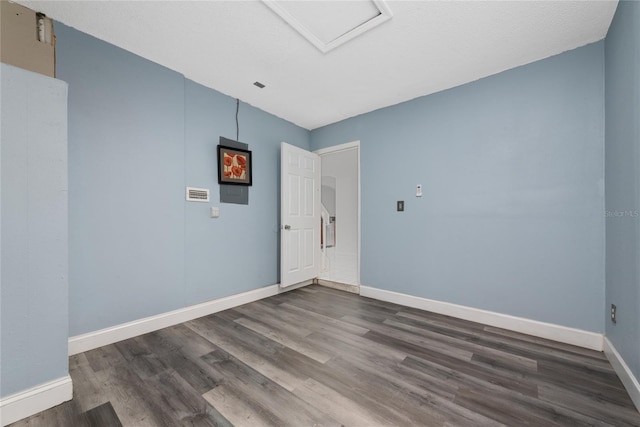 spare room with dark hardwood / wood-style floors