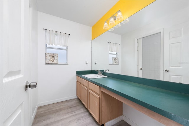 bathroom with hardwood / wood-style flooring and vanity