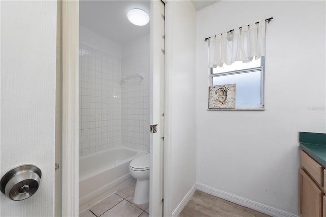 full bathroom with vanity, tile patterned floors, toilet, and tiled shower / bath