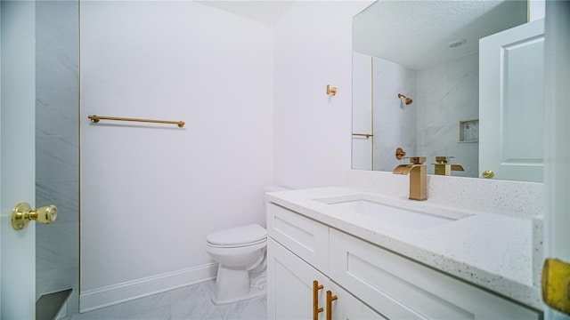 bathroom with toilet, marble finish floor, baseboards, walk in shower, and vanity