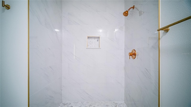 bathroom with a tile shower