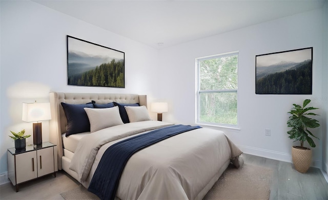 bedroom with light wood-style flooring and baseboards