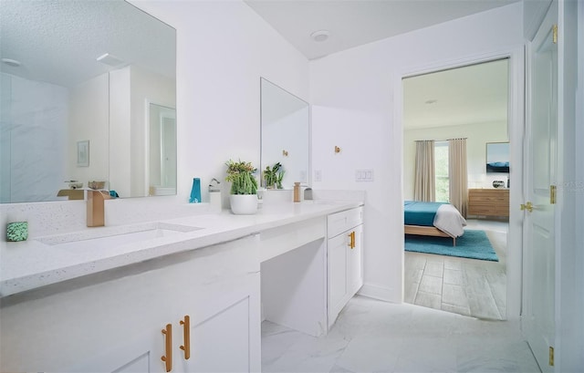 bathroom with a textured ceiling and vanity