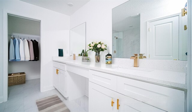 bathroom featuring vanity, a shower with shower door, and tile patterned flooring