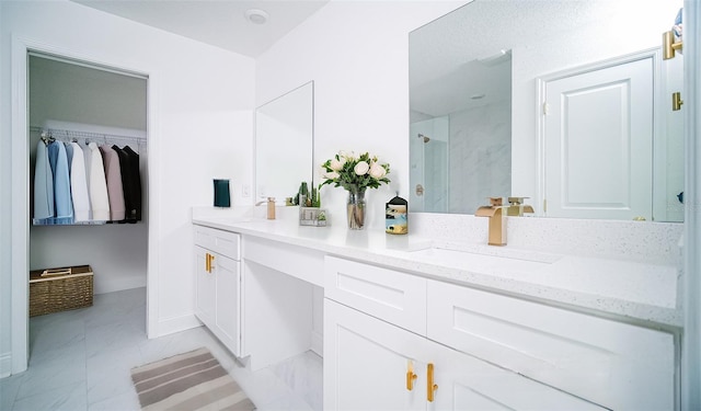 bathroom with a sink, double vanity, and a shower stall