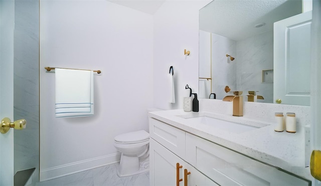 bathroom with baseboards, toilet, walk in shower, and vanity