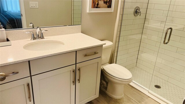 bathroom featuring vanity, toilet, and an enclosed shower