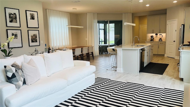 living room featuring light hardwood / wood-style floors and sink