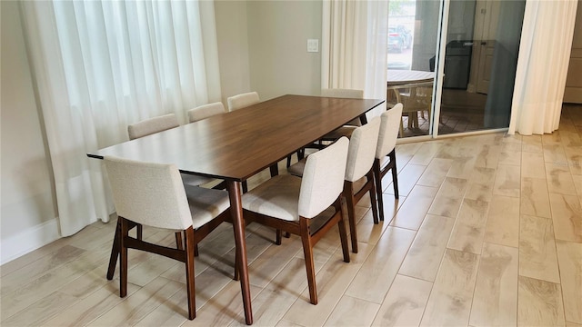 dining area with light hardwood / wood-style flooring