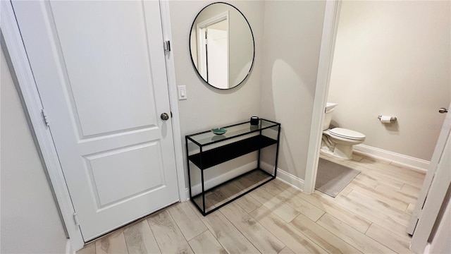 bathroom with hardwood / wood-style floors and toilet