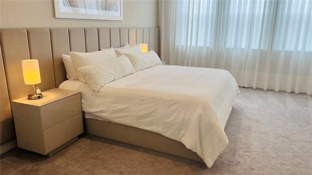 bedroom featuring light colored carpet