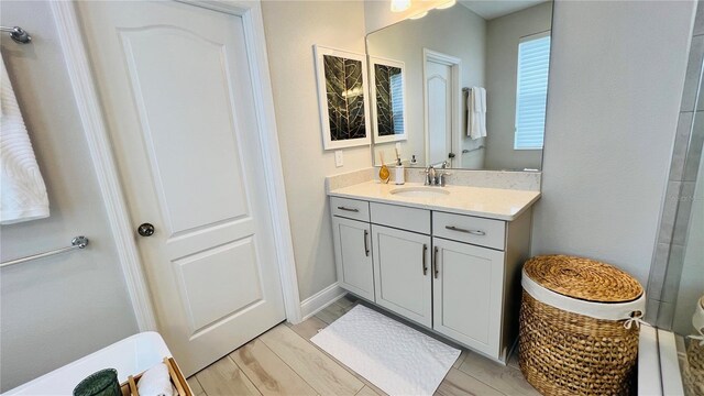 bathroom featuring hardwood / wood-style flooring, vanity, and toilet