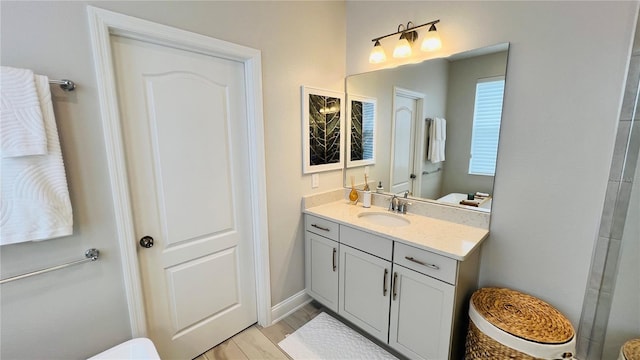 bathroom with wood-type flooring, vanity, and toilet