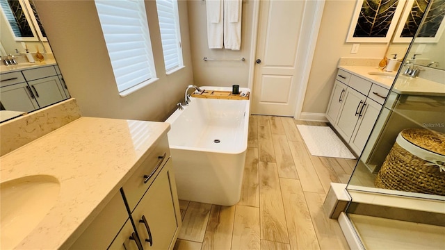 bathroom featuring vanity, a tub, and hardwood / wood-style floors